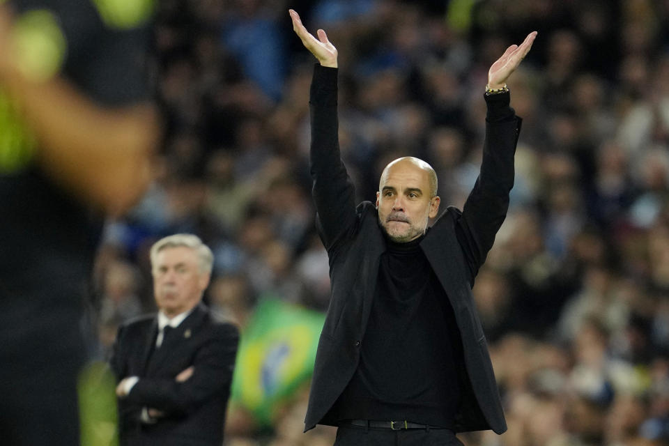 Manchester City's head coach Pep Guardiola applauds during the Champions League semifinal second leg soccer match between Manchester City and Real Madrid at Etihad stadium in Manchester, England, Wednesday, May 17, 2023. (AP Photo/Jon Super)