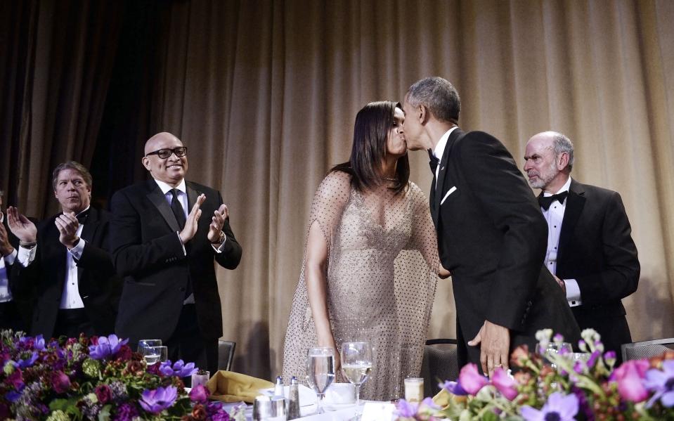 <p>The President kisses the First Lady at their eighth and final White House dinner. <em>[Photo: Getty]</em> </p>