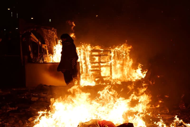 French gendarmes evacuate makeshift migrant camp in the outskirts of Paris