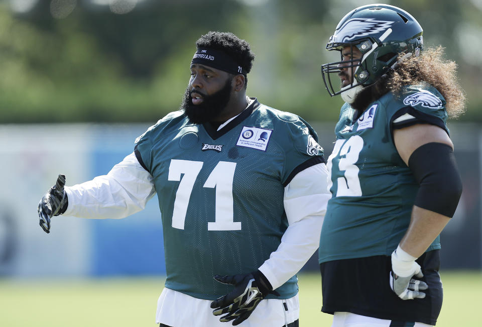 Philadelphia Eagles offensive tackle Jason Peters (71) talks to teammate Isaac Seumalo during an NFL football training camp practice in Philadelphia, Monday, Aug. 17, 2020. (Yong Kim/Pool Photo via AP)