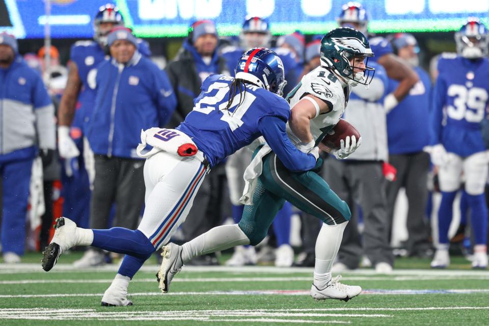 Jan 7, 2024; East Rutherford, New Jersey, USA; Philadelphia Eagles wide receiver Britain Covey (18) is tackled by New York Giants safety Dane Belton (24) during the second half at MetLife Stadium. Mandatory Credit: Vincent Carchietta-USA TODAY Sports