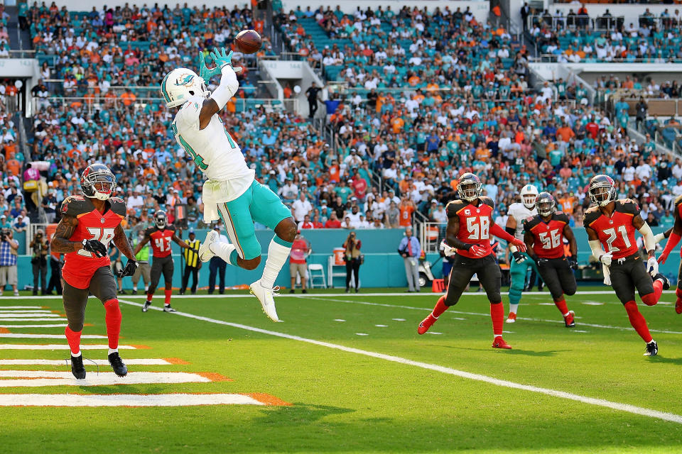 <p>Jarvis Landry #14 of the Miami Dolphins makes the catch for a touchdown in the first quarter during a game against the Tampa Bay Buccaneers at Hard Rock Stadium on November 19, 2017 in Miami Gardens, Florida. (Photo by Mark Brown/Getty Images) </p>