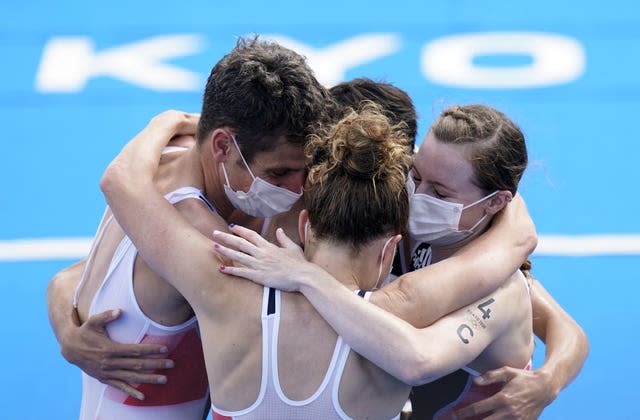 Georgia Taylor-Brown, right, celebrates winning gold in the mixed relay in Tokyo with her Great Britain team-mates 