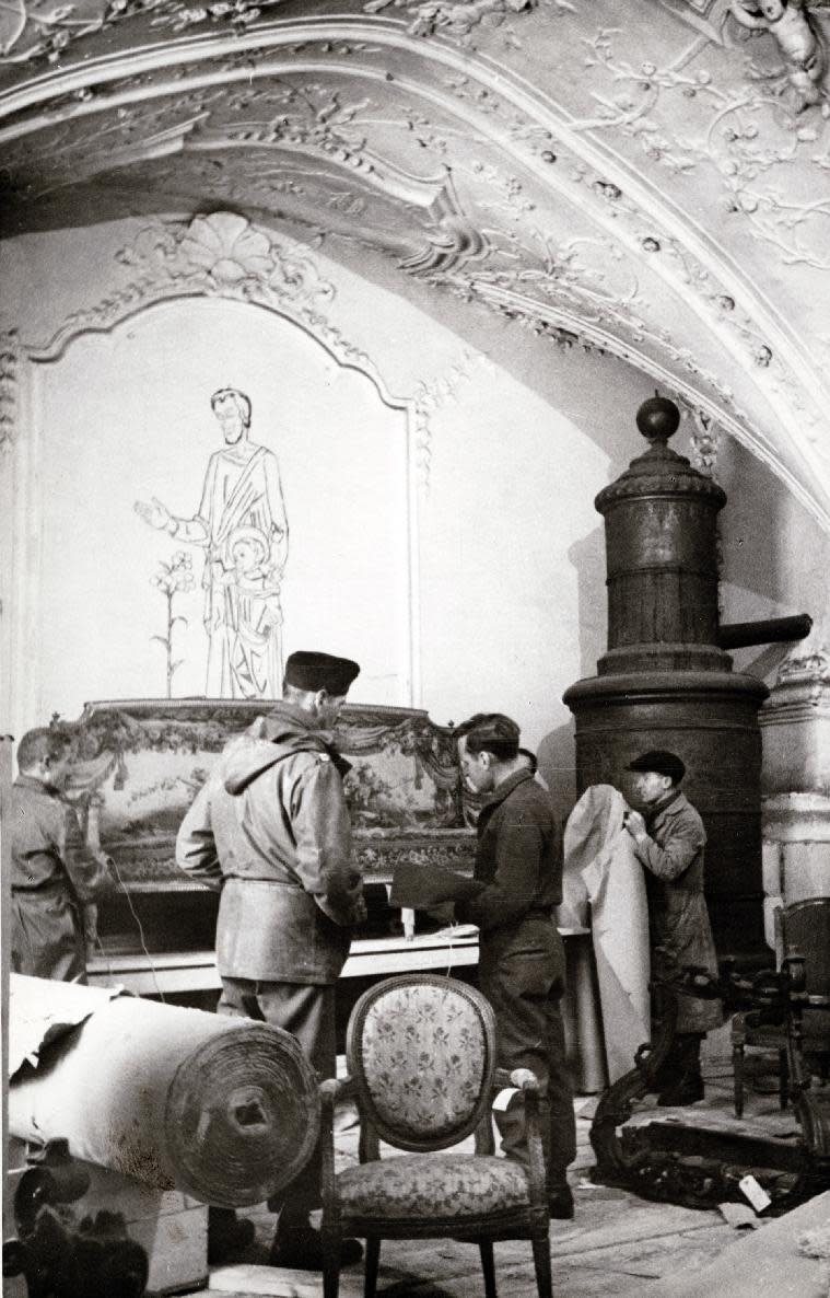 This 1945 handout photo provided by the Smithsonian Institution shows the rescuing of art from Buxheim Monastery, Bavaria, Photographs, maps and records from the real corps of soldiers known as “Monuments Men” who were tasked with protecting European cultural sites and recovering looted art during World War II are going on display in Washington, many for the first time. (AP Photo/Edward E. Adams, Smithsonian Institution)