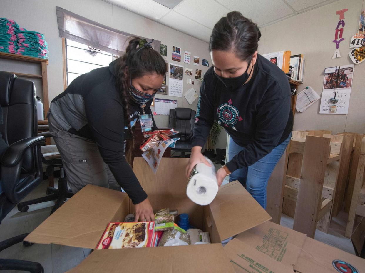 <span class="caption">At the Navajo Nation town of Fort Defiance, Arizona, staff pack food boxes. The Navajo Nation now has the highest per capita COVID-19 infection rate in the U.S. </span> <span class="attribution"><a class="link " href="https://www.gettyimages.com/detail/news-photo/staff-from-the-john-hopkins-center-for-american-indian-news-photo/1214296194?adppopup=true" rel="nofollow noopener" target="_blank" data-ylk="slk:Getty Images / Mark Ralston;elm:context_link;itc:0;sec:content-canvas">Getty Images / Mark Ralston</a></span>