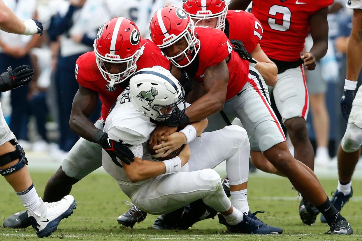 Georgia linebacker Nolan Smith (4) takes down Samford quarterback Michael Hiers (10) during the first half of a NCAA college football game between Samford and Georgia in Athens, Ga., on Saturday, Sept. 10, 2022.