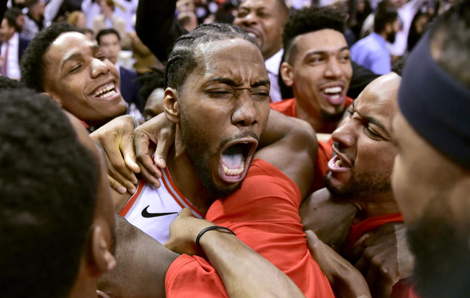 Toronto Raptors forward Kawhi Leonard, center, celebrates his game-winning basket as time expired at the end of an NBA Eastern Conference semifinal basketball game against the Philadelphia 76ers, in Toronto on Sunday, May 12, 2019. Toronto won 92-90. (Frank Gunn/The Canadian Press via AP)