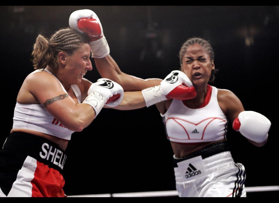 Laila Ali (R) of the US gets caught by a punch from Shelley Burton of the US during their WBC Super Middleweight Championship fight, 11 November 2006, at Madison Square Garden in New York.  