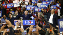 Sen. Kamala Harris, D-Calif., from left, Democratic presidential candidate former Vice President Joe Biden, Michigan Gov. Gretchen Whitmer, and Sen. Cory Booker D-N.J. greet the crowd during a campaign rally at Renaissance High School in Detroit, Monday, March 9, 2020. (AP Photo/Paul Sancya)