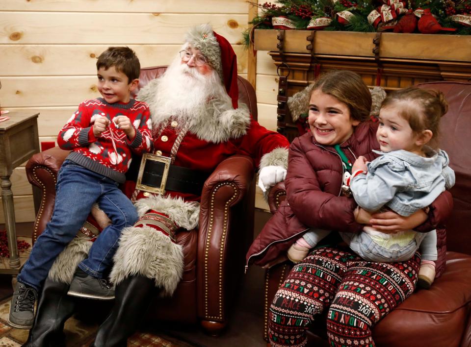 Santa sits with a group of children at the Mayor's Tree Lighting and Holiday Show on Park Central Square in Springfield on Nov. 18, 2023.