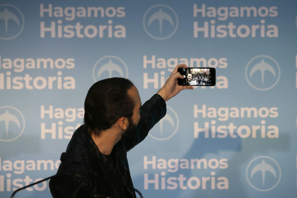 FILE - In this Feb. 3, 2019 file photo, then presidential frontrunner Nayib Bukele takes a selfie during a press conference, in San Salvador, El Salvador. Like former President Donald Trump, Bukele prefers social media over press conferences, so he can control the message. (AP Photo/Moises Castillo, File)