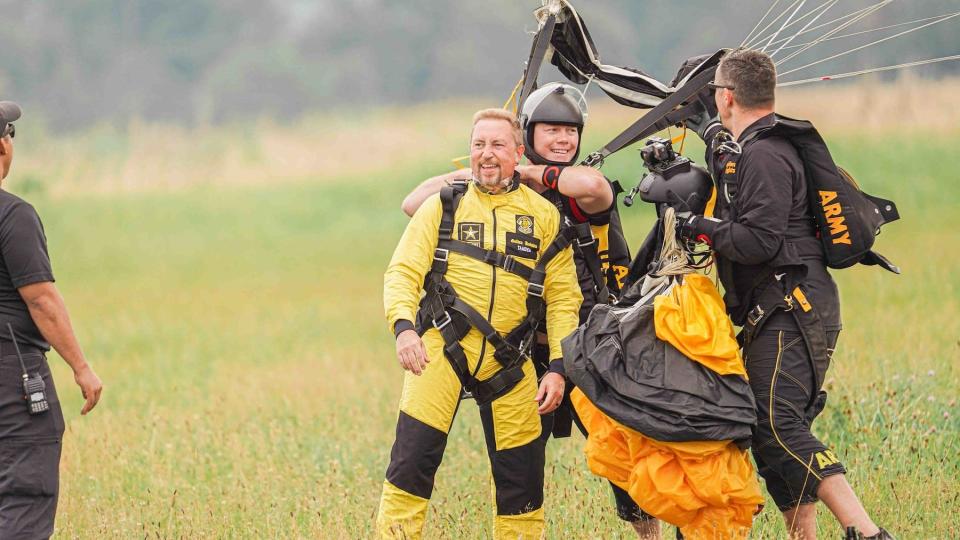 Dr. Chad Brooks, dean of APSU's College of Graduate Studies, lands in Addington Field outside Fort Knox, Kentucky on July 12 after a tandem jump with the U.S. Army Parachute Team (Photo 1, U.S. Army photo by 7th Brigade ROTC).