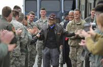 FILE- Retired U.S. Air Force Col. Charles McGee, center, a decorated veteran of three wars, receives a congratulatory send off after visiting with 436 Aerial Port Squadron personnel at Dover Air Force Base to help celebrate his 100th birthday in Dover, Delaware, Friday, Dec. 6, 2019. McGee, one of the last surviving Tuskegee Airmen who flew 409 fighter combat missions over three wars, died Sunday, Jan. 16, 2022. He was 102. (AP Photo/David Tulis, File)