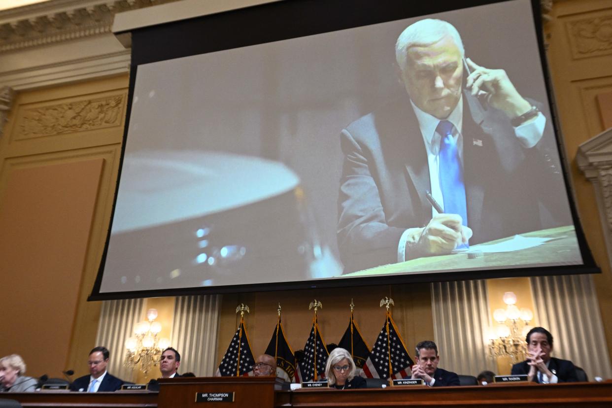 An image on a screen shows former US Vice President Mike Pence looking at his phone as he shelters in a secure underground location after being evacuated from the Senate chamber on January 6, 2021, during a hearing of the US House Select Committee to Investigate the January 6 Attack on the US Capitol, on Capitol Hill in Washington, DC, on June 16, 2022. (Mandel Ngan/AFP via Getty Images)