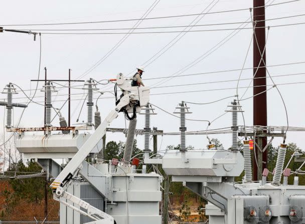 PHOTO: Duke Energy personnel work to restore power at a second crippled electrical substation after the Moore County Sheriff said that vandalism caused a mass power outage, in Carthage, N.C., on Dec. 4, 2022.  (Jonathan Drake/Reuters)