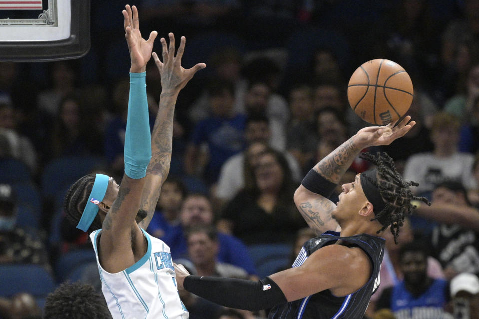 Orlando Magic forward Paolo Banchero, right, goes up for a shot in front of Charlotte Hornets forward Jalen McDaniels (6) during the first half of an NBA basketball game, Friday, Oct. 28, 2022, in Orlando, Fla. (AP Photo/Phelan M. Ebenhack)