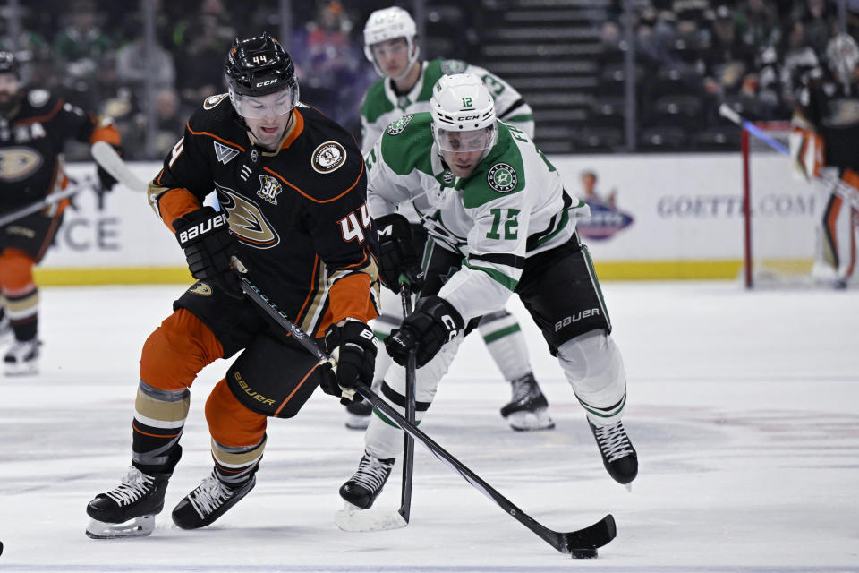 Anaheim Ducks left wing Ross Johnston (44) controls the puck against Dallas Stars center Radek Faksa (12) during the first period of an NHL hockey game in Anaheim, Calif., Friday, March 8, 2024. (AP Photo/Alex Gallardo)