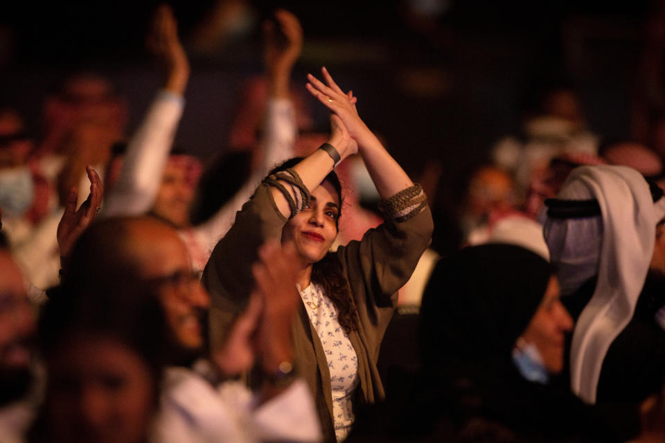 In this July 8, 2021 photo, a coronavirus vaccinated audience cheers as Saudi prominent singer Mohammed Abdu performs at the newly built Super Dome, in Jiddah, Saudi Arabia. The concert is organized by the Saudi General Entertainment Authority after the kingdom lifted coronavirus restrictions on events in May. (AP Photo/Amr Nabil)