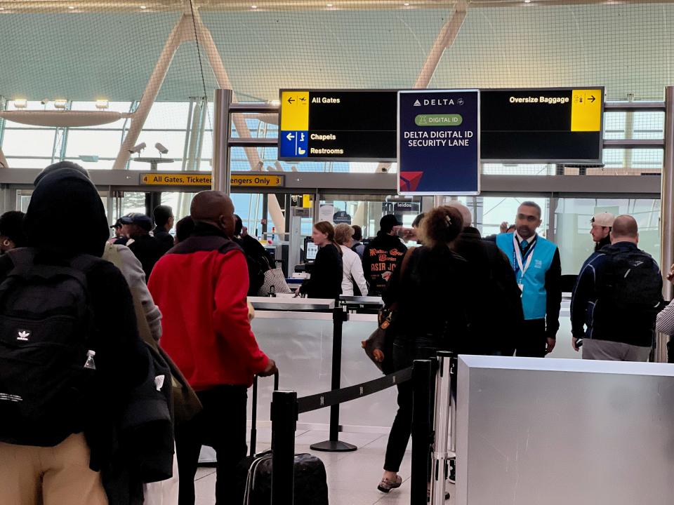 People standing in Delta's digital ID lane at security.