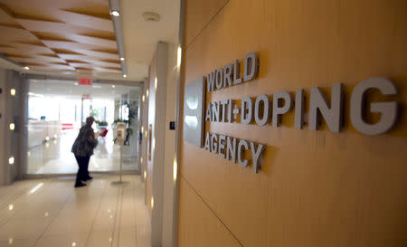 FILE PHOTO: A woman walks into the head office of the World Anti-Doping Agency (WADA) in Montreal, Quebec, Canada November 9, 2015. REUTERS/Christinne Muschi/File Photo