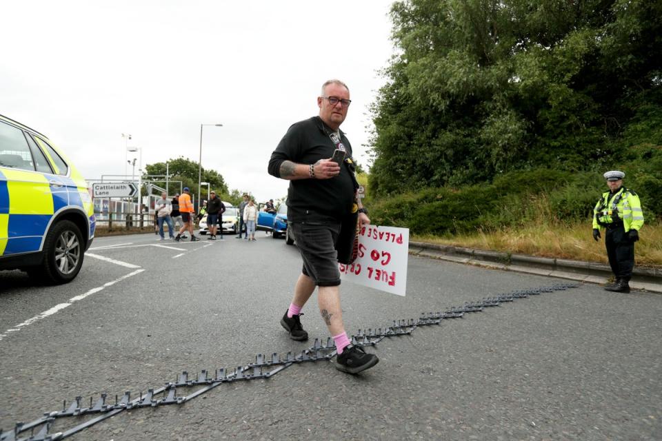A protester walks over a police stinger as motorways are brought to a standstill (Getty Images)