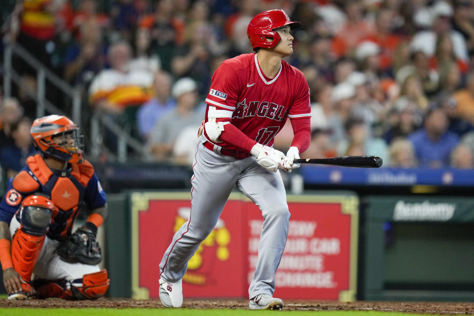 Los Angeles Angels designated hitter Shohei Ohtani, right, watches his solo home run during the sixth inning of a baseball game against the Houston Astros, Sunday, Aug. 13, 2023, in Houston. (AP Photo/Eric Christian Smith)