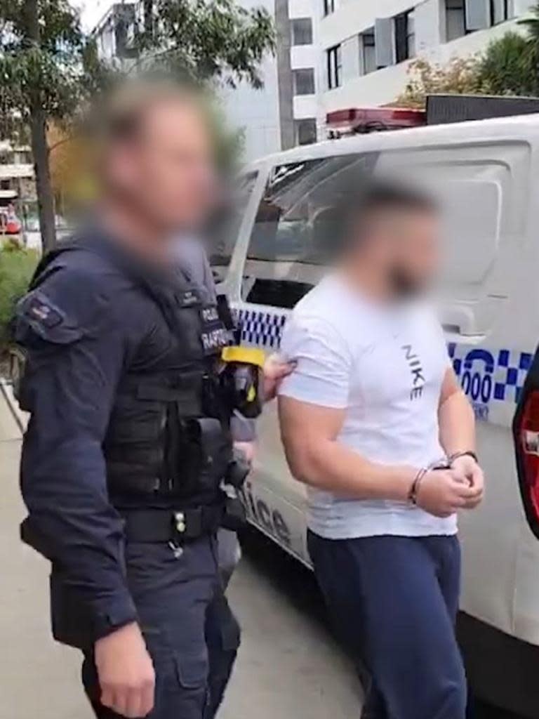 The 20-year-old man is led away by police following his arrest on Thursday. Picture: Supplied / NSW Police