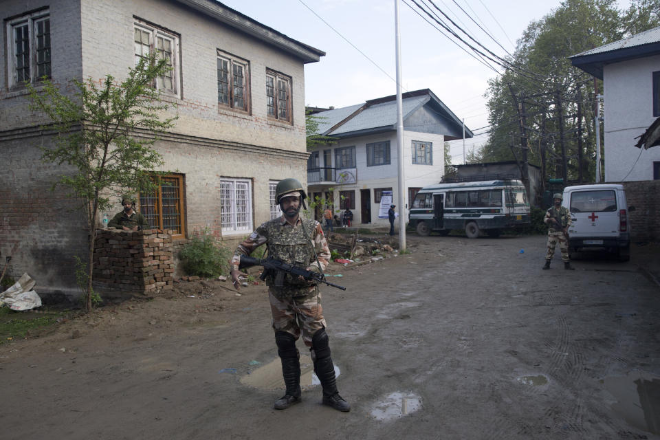 Indian paramilitary soldiers stand guard outside a polling station during the second phase of India's general elections, in Srinagar, Indian controlled Kashmir, Thursday, April 18, 2019. Kashmiri separatist leaders who challenge India's sovereignty over the disputed region have called for a boycott of the vote. Most polling stations in Srinagar and Budgam areas of Kashmir looked deserted in the morning with more armed police, paramilitary soldiers and election staff present than voters. (AP Photo/ Dar Yasin)