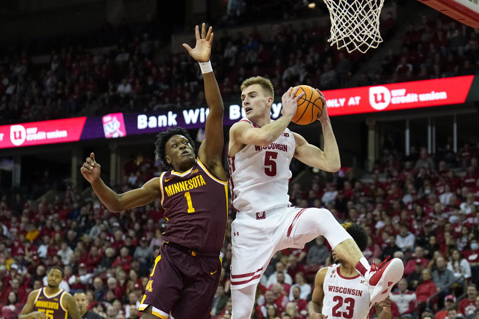 Wisconsin's Tyler Wahl (5) grabs a defensive rebound next to Minnesota's Joshua Ola-Joseph (1) during the first half of an NCAA college basketball game Tuesday, Jan. 3, 2023, in Madison, Wis. (AP Photo/Andy Manis)