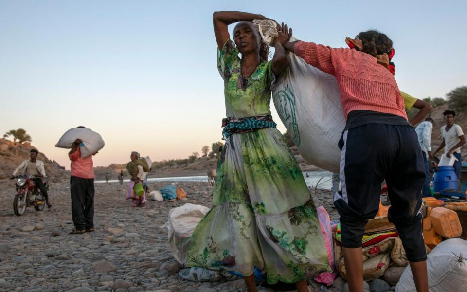 Tigrayan refugees receive aid after fleeing into Sudan - AP