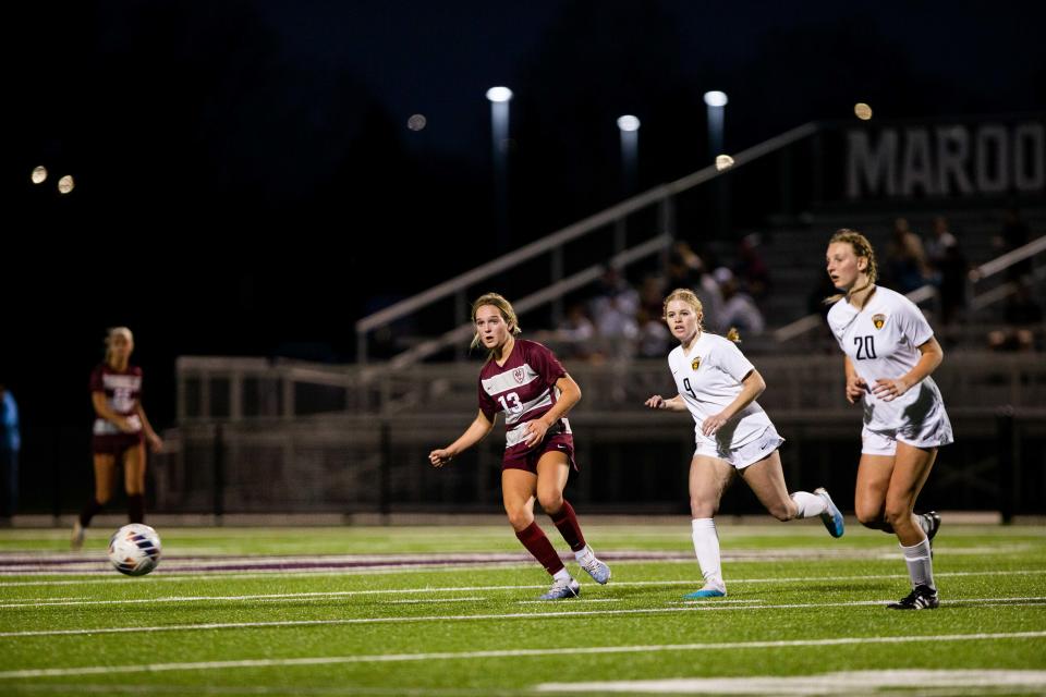 Holland Christian's Sarah Geerlings passes the ball to a teammate Wednesday, April 12, 2023, at Holland Christian. 