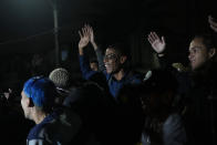 Youths attend the Gas Battle rapping competition outside a bar in the City of God favela of Rio de Janeiro, Brazil, late Wednesday, Nov. 10, 2021. Rap artists in the favela are starting to compete again since the COVID-19 pandemic curtailed public gatherings, presenting local residents with a show in a sign of a return to normalcy for music lovers. (AP Photo/Silvia Izquierdo)