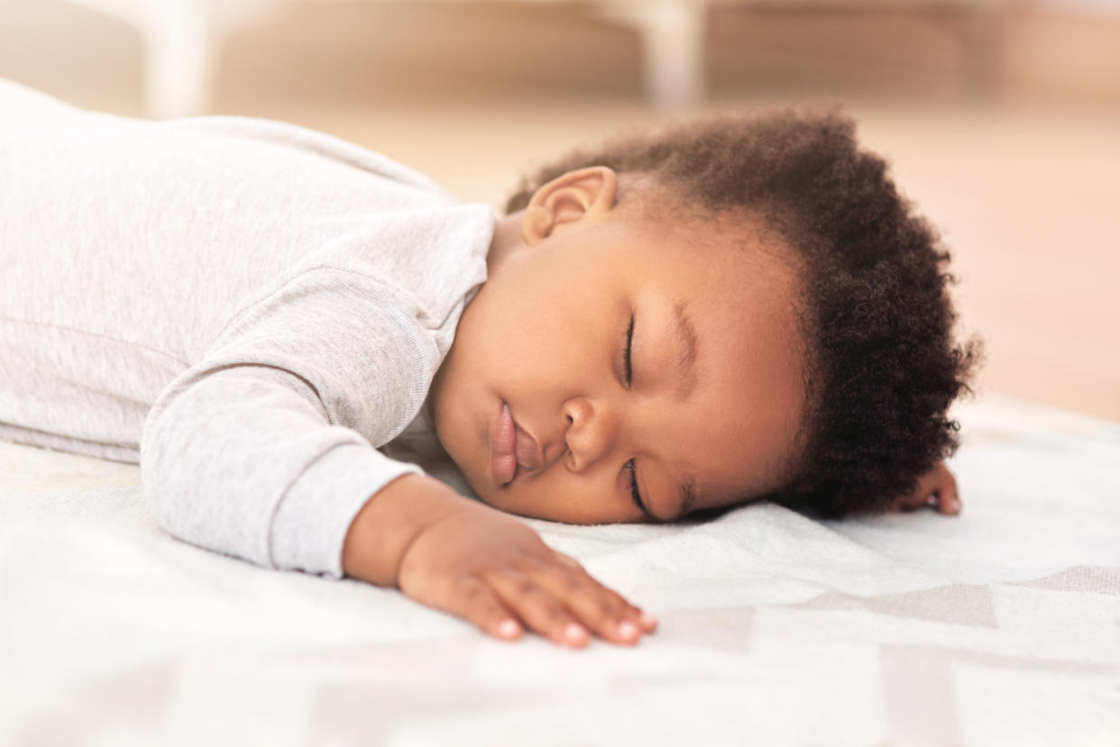 Shot of a little baby boy sleeping on a bed