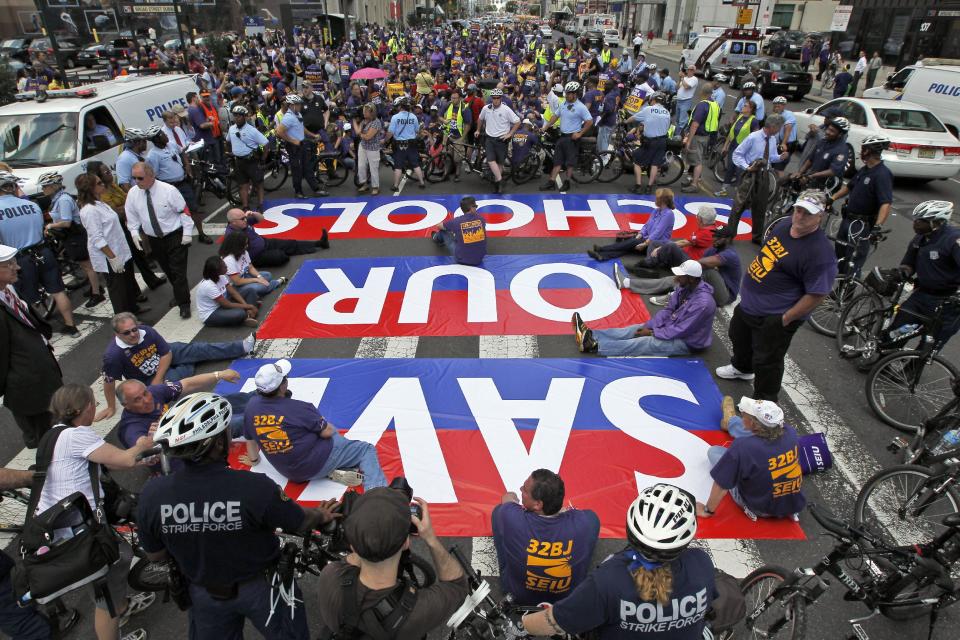 Protestors are ringed by Philadelphia police as they sit in Broad Street in an ac of civil disobedience during a protest of Pennsylvania Gov. Tom Corbett's proposed cuts to the education budget Wednesday, May 23, 2012 in Philadelphia. (AP Photo/Alex Brandon)