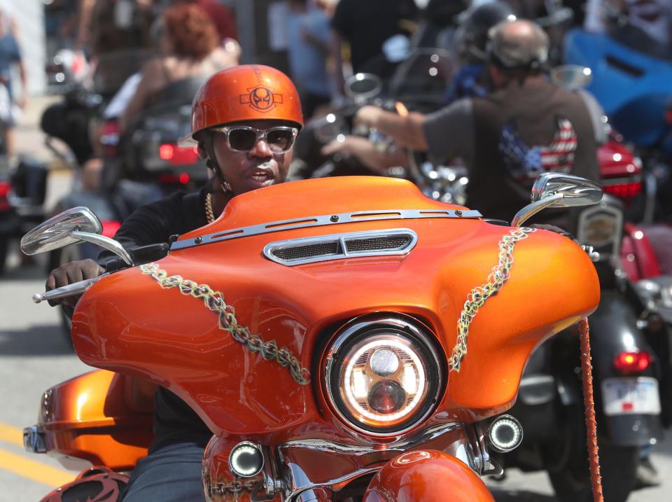 Riders cruise Main Street on Friday as Bike Week rolls toward its closing weekend in Daytona Beach. Although merchants on Main Street report booming business, area hoteliers had a harder time filling rooms, possibly due to the influence of rainy weather forecasts.