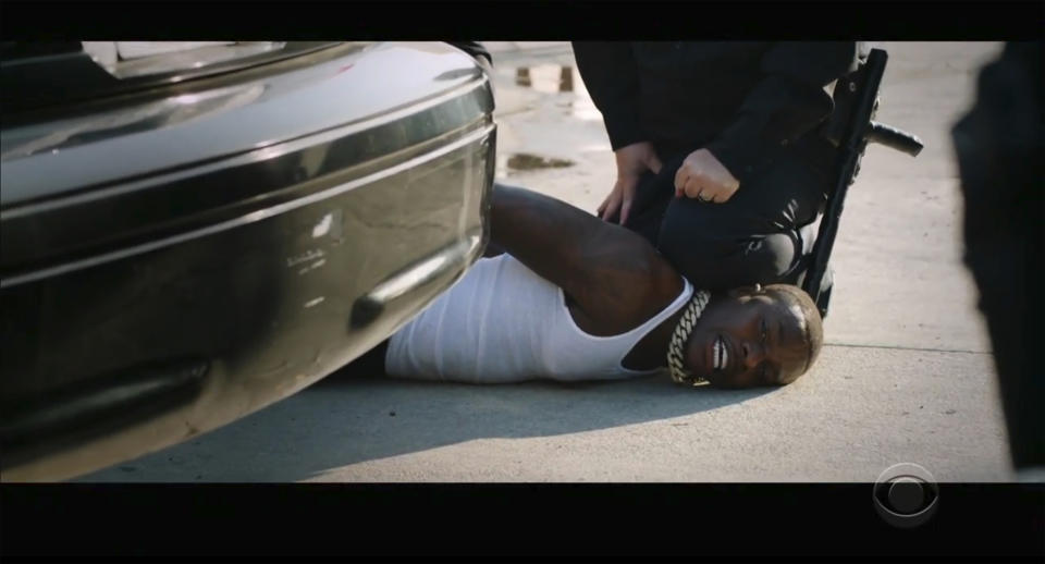 In this video grab issued Sunday, June 28, 2020, by BET, rapper DaBaby performs "Rockstar" as an actor playing a police officer presses his knee on DaBaby's neck, replicating the last few moments of George Floyd's life, during the BET Awards. (BET via AP)