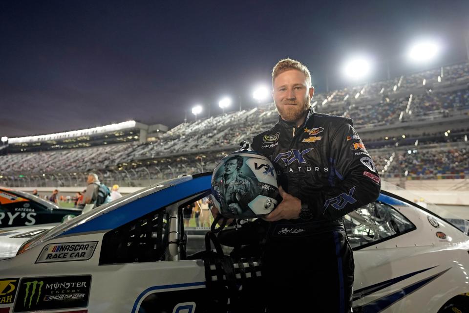Jeffrey Earnhardt (00) poses with a his helmet with the likeness of late grandfather Dale Earnhardt painted by Off Axis Paint prior to a Duel race at Daytona in 2018.