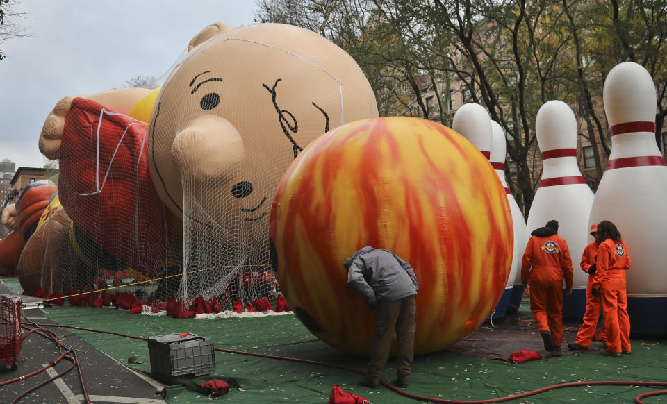 Giant character balloons, including Charlie Brown and Go Bowling, are inflated the night before their appearance in the 92nd Macy's Thanksgiving Day parade, Wednesday Nov. 21, 2018, in New York. (AP Photo/Bebeto Matthews)