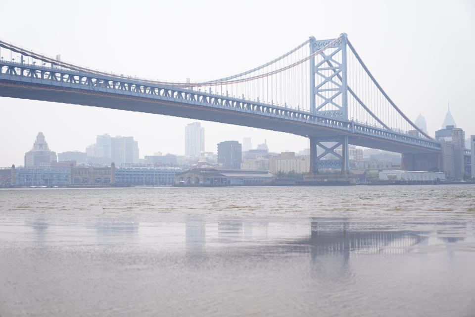 <p>The Benjamin Franklin Bridge and the Philadelphia skyline are shrouded in haze, Wednesday, June 7, 2023. Intense Canadian wildfires are blanketing the northeastern U.S. in a dystopian haze, turning the air acrid, the sky yellowish gray and prompting warnings for vulnerable populations to stay inside. (AP Photo/Matt Rourke)</p> 