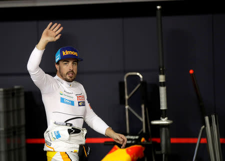 McLaren driver Fernando Alonso of Spain waves to spectators in the pit during the qualifying session at the Yas Marina racetrack in Abu Dhabi, United Arab Emirates November 24, 2018. Luca Bruno/ Pool via REUTERS