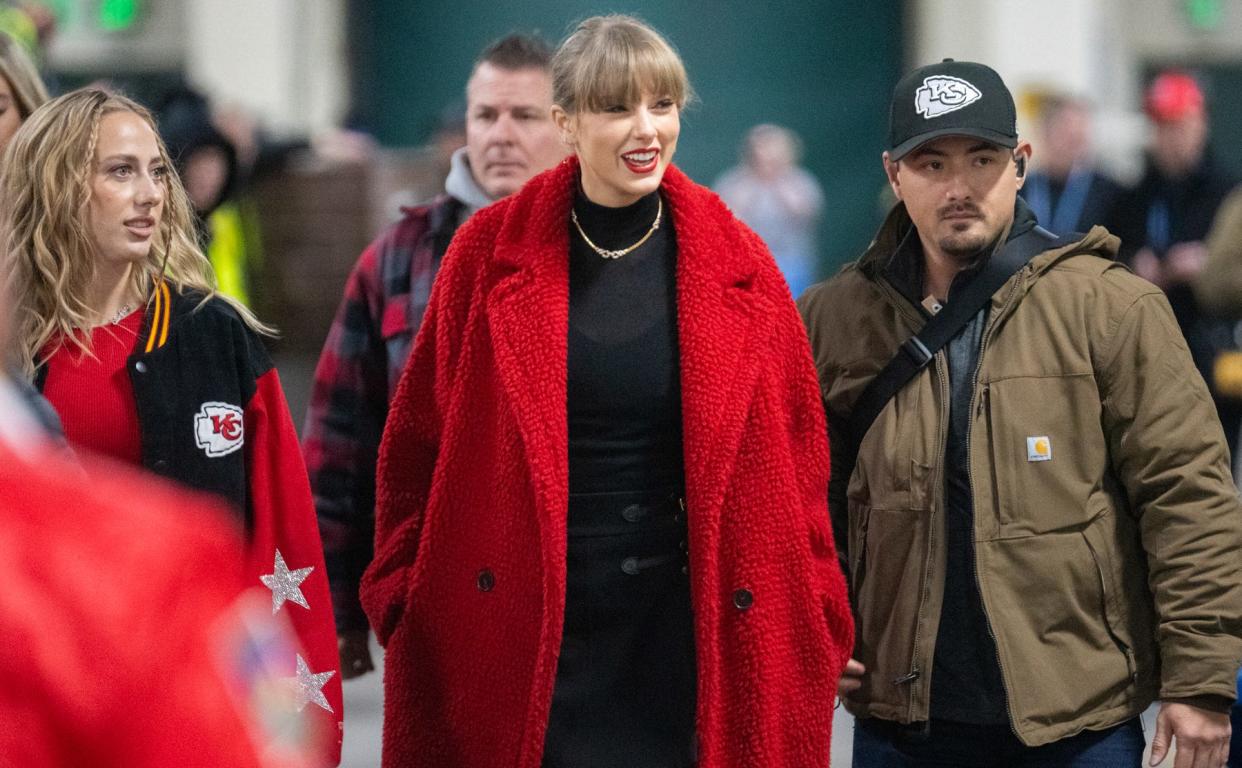 Taylor Swift (center) is shown before the Green Bay Packers-Kansas City Chiefs game on December 3, 2023 at Lambeau Field in Green Bay, Wis.