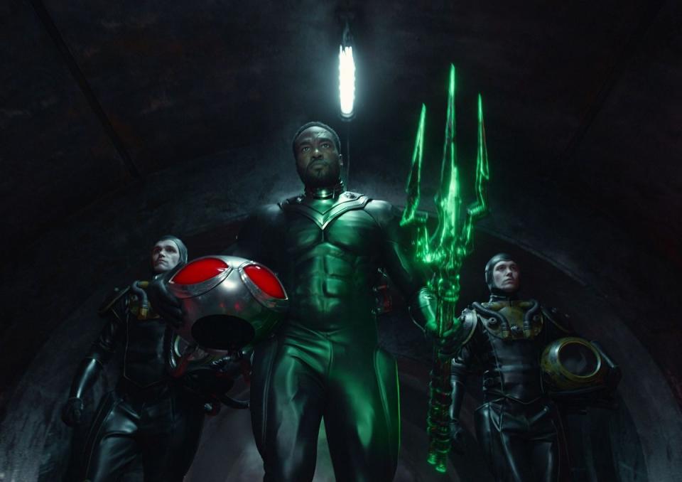 Black Manta (Yahya Abdul-Mateen II) wields the mysterious Black Trident, flanked by goons, in Aquaman: The Lost Kingdom.