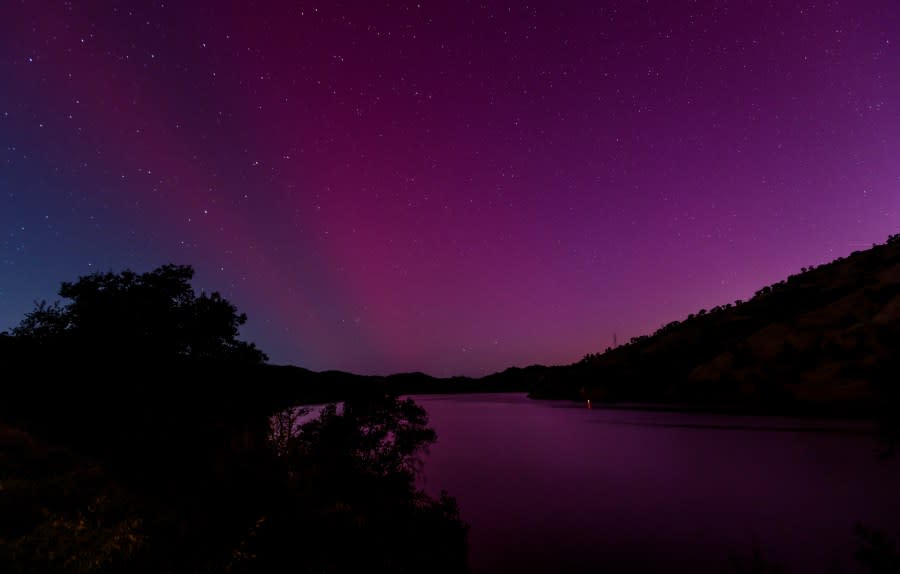 The Aurora Borealis, also known as the Northern Lights, is visible over Lake Berryessa, Calif., early Saturday, May, 11, 2024. (Carlos Avila Gonzalez/San Francisco Chronicle via AP)