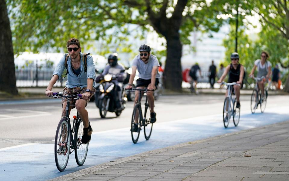 People ride bicycles in a bike lane in Chelsea, London, after the government unveiled a further Â£250 million for extra cycle lanes as the UK prepares for the lifting of the coronavirus lockdown in England.  - PA
