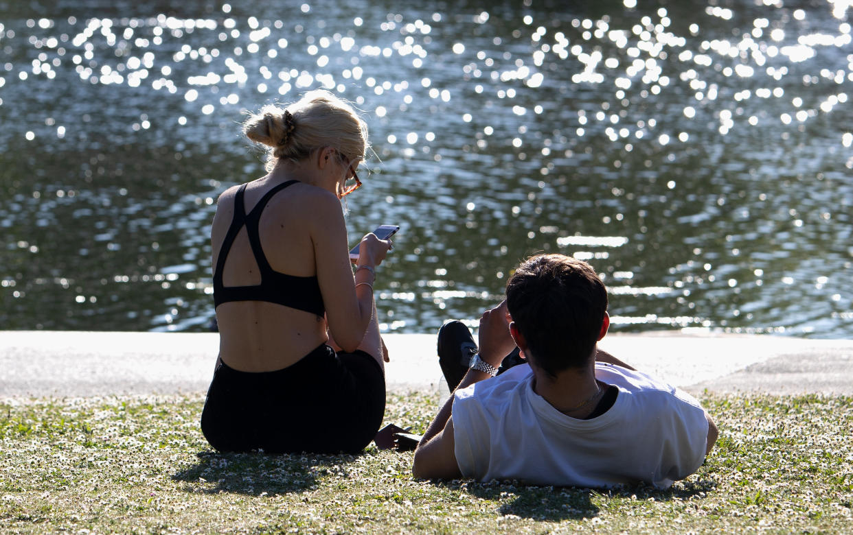 LONDON, ENGLAND - MAY 20: A couple sunbathing by the lake in Regents Park on May 20, 2020 in London. The British government has started easing the lockdown it imposed two months ago to curb the spread of Covid-19, abandoning its 'stay at home' slogan in favour of a message to 'be alert', but UK countries have varied in their approaches to relaxing quarantine measures. (Photo by Jo Hale/Getty Images)
