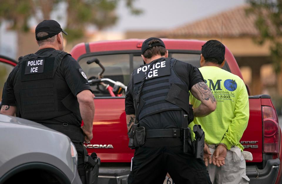 In this July 8, 2019 file photo, U.S. Immigration and Customs Enforcement (ICE) officers detain a man during an operation in Escondido, Calif.