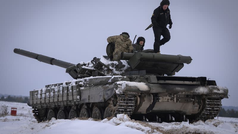 Ukrainian soldiers practice on a tank during military training in Ukraine Wednesday, Dec. 6, 2023.