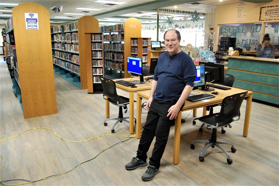 Director Corey Bard shows off the new wooden flooring that replaced 30-year-old carpeting in the Bloomfield Public LIbrary on Jan. 12.