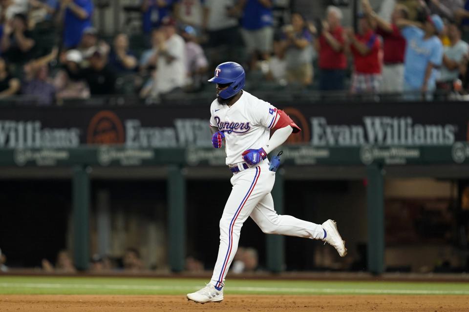 Texas Rangers' Adolis Garcia runs the bases after hitting a two-run home run against the Oakland Athletics during the fifth inning of a baseball game in Arlington, Texas, Tuesday, Sept. 13, 2022. (AP Photo/Tony Gutierrez)