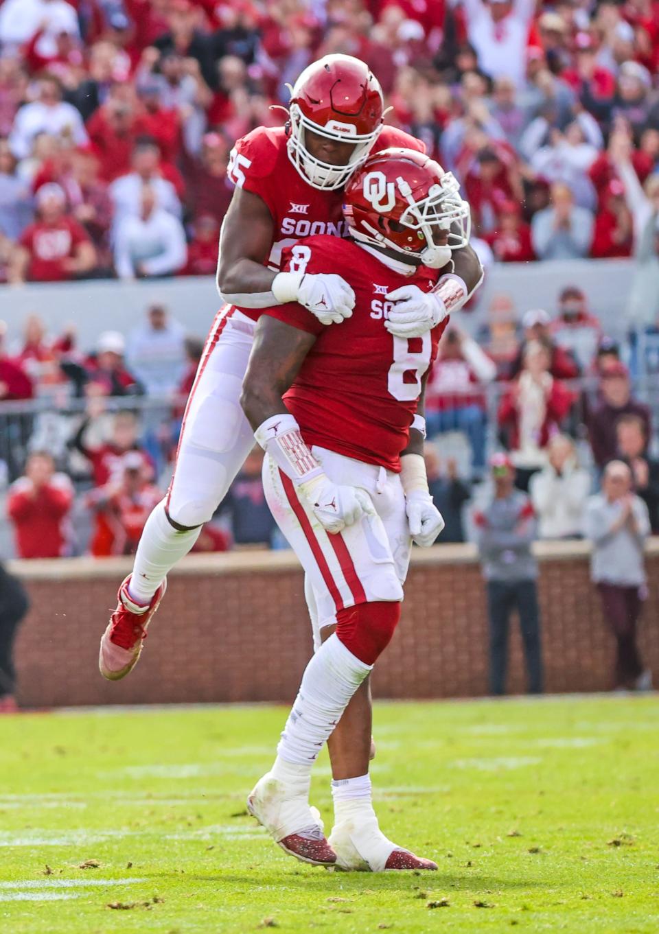 Nov 20, 2021; Norman, Oklahoma, USA; Oklahoma Sooners defensive lineman Perrion Winfrey (8) celebrates with  defensive lineman Isaiah Thomas (95) during the first quarter against the Iowa State Cyclones at Gaylord Family-Oklahoma Memorial Stadium. Mandatory Credit: Kevin Jairaj-USA TODAY Sports